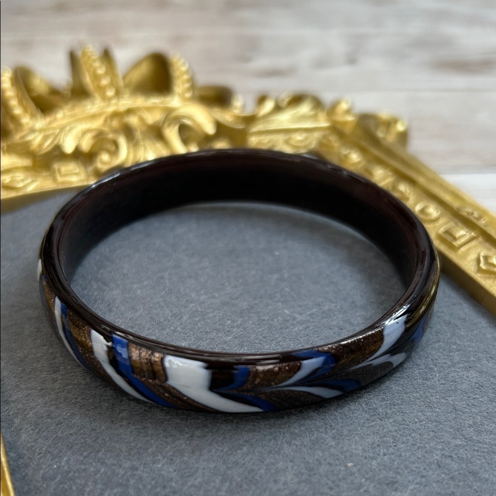Elegant glass bracelet (or bangle) with a swirled, multi-color design